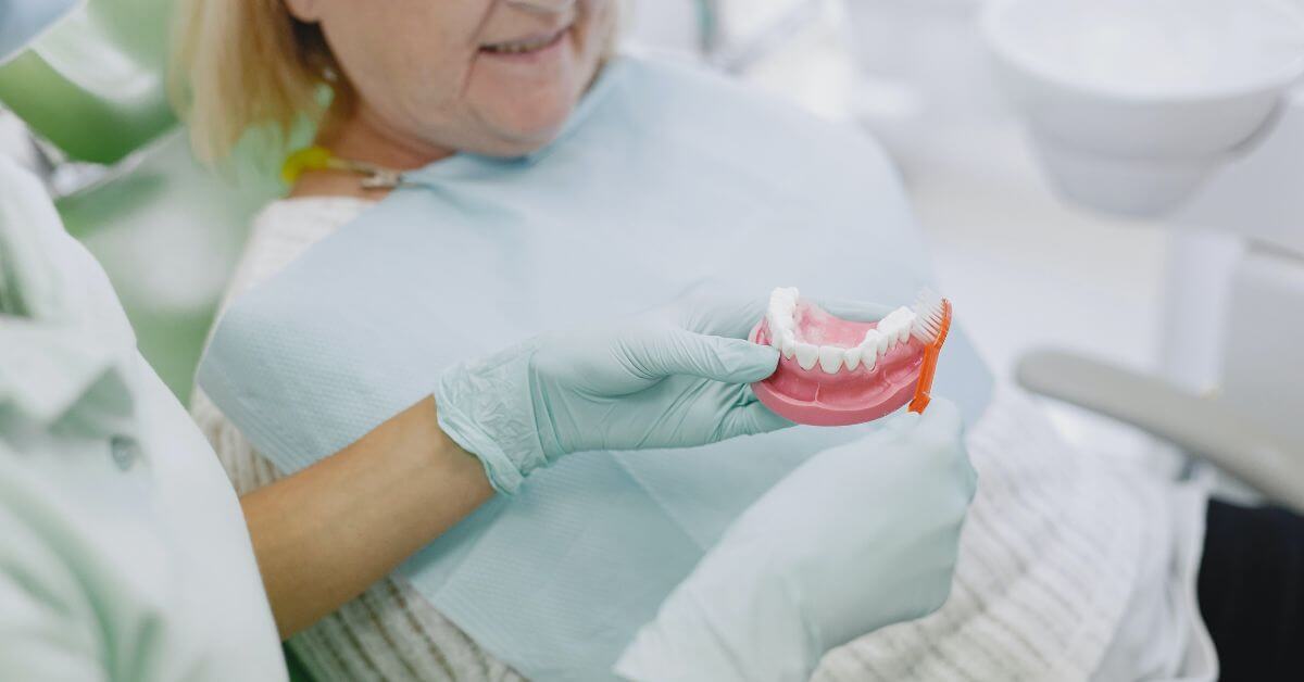 woman looking at her new dentures